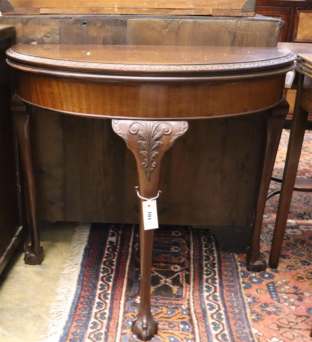 An early 20th century mahogany folding demi lune card table, width 83cm, depth 42cm, height 75cm,